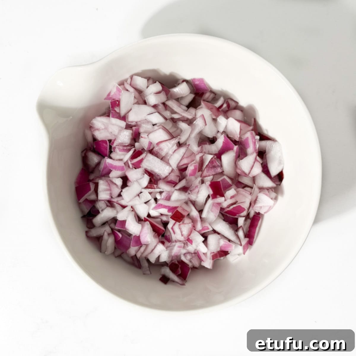 Poppadom Perfection: Indian Onion Chutney 9 Soaked and dried onions in a white bowl.