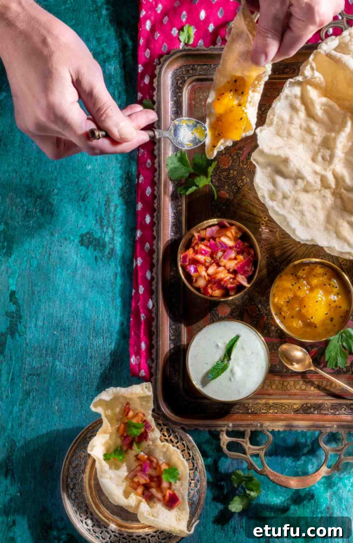 Poppadom Dip Delights 2 Various dips for poppadoms in small bowls on a gold tray, surrounded by crispy poppadoms.