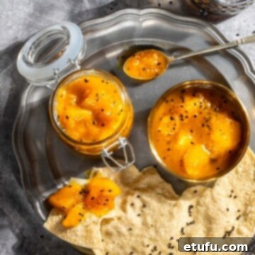 Poppadom Dip Delights 7 Homemade Indian mango chutney in a glass jar and a small bowl, served with crispy poppadoms on a white plate.