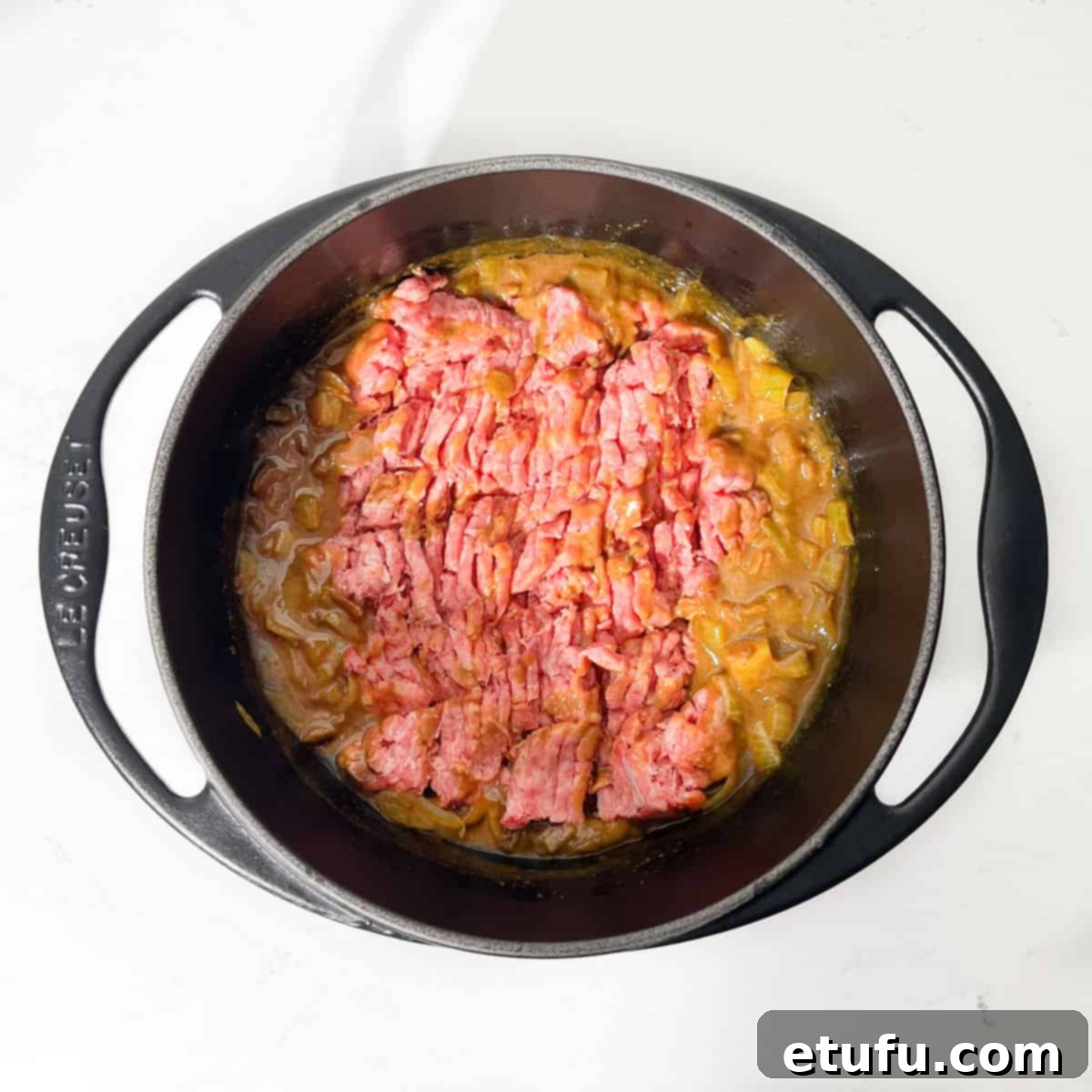Adding mince to the curried onion mixture for the curried mince.