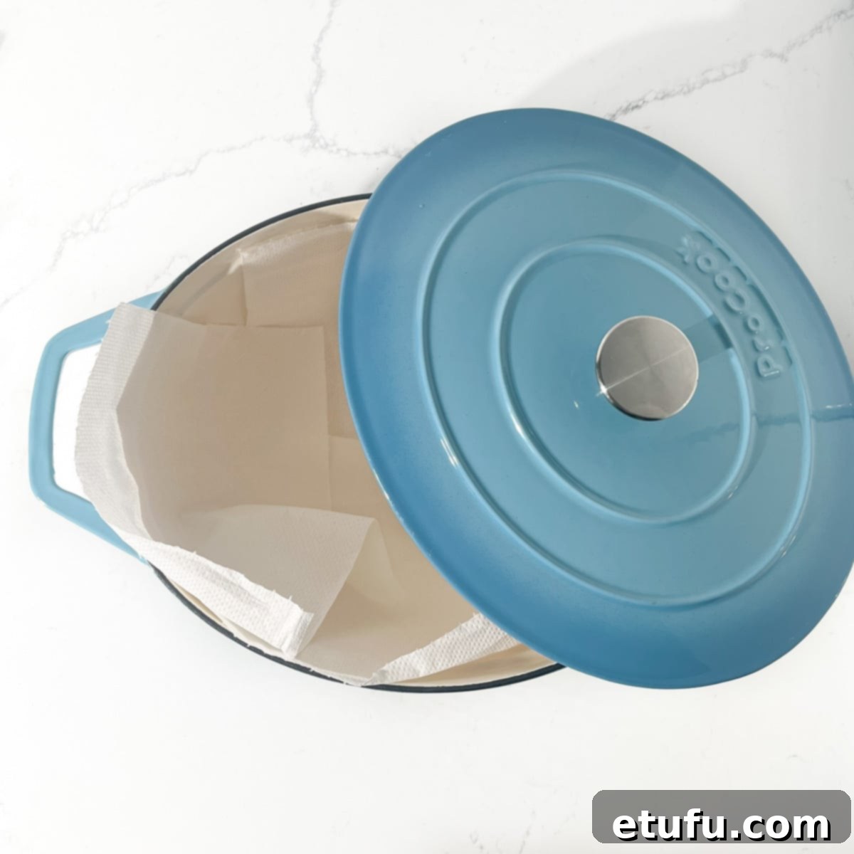 A large pot lined with kitchen paper to place cooked vetkoek in.