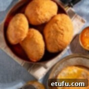 A bowl of vetkoek next to a plate with one vetkoek, drizzled in golden syrup.