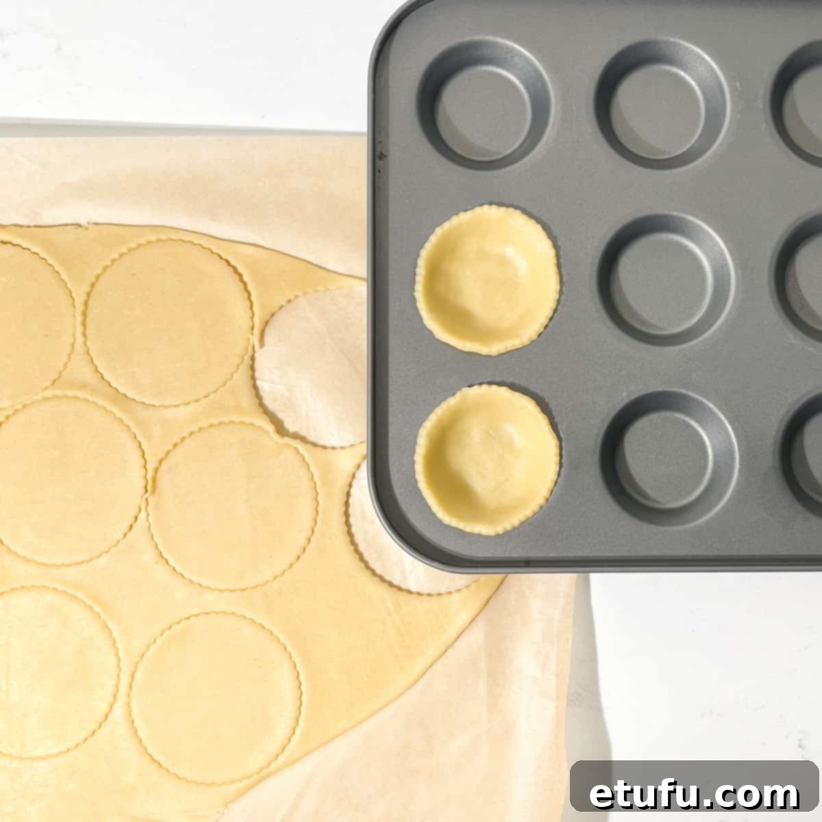 Cutting neat circles from the pastry dough using a round cutter.
