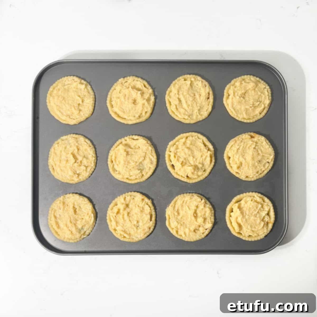 Frangipane mince pies in a fairy tin, topped with the smooth frangipane mixture.