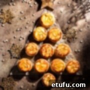 Frangipane mince pies packed in a Christmas tree shape on a brown background.