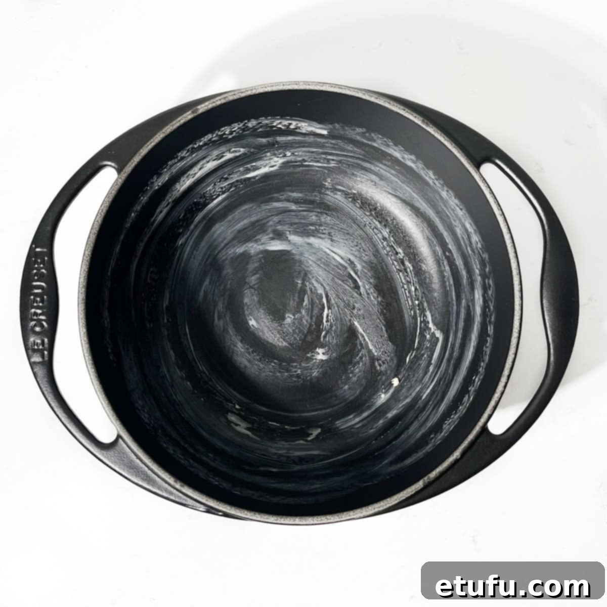 A saucepan lightly coated with butter, preventing milk from sticking during Melkkos preparation.