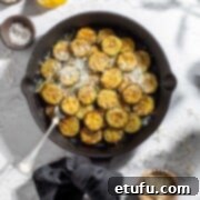 Crispy Fried Zucchini 13 Fried courgettes in a black frying pan.
