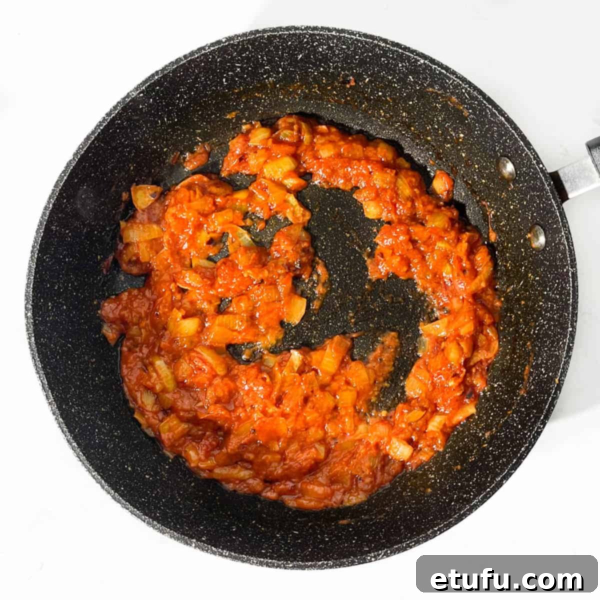 Sauce for masala chips in a frying pan.