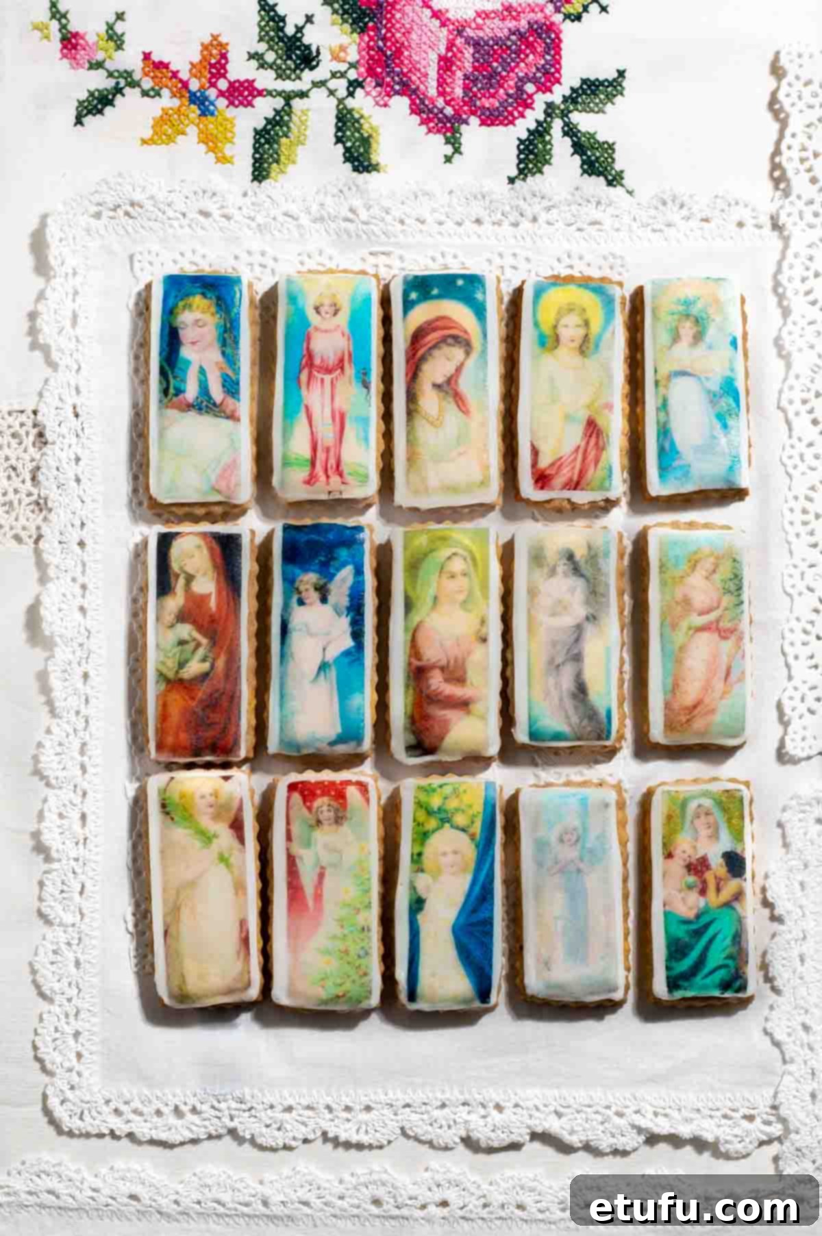 Christmas cookies with edible wafer on an embroidered tablecloth. Personalized photo cookies for Christmas.