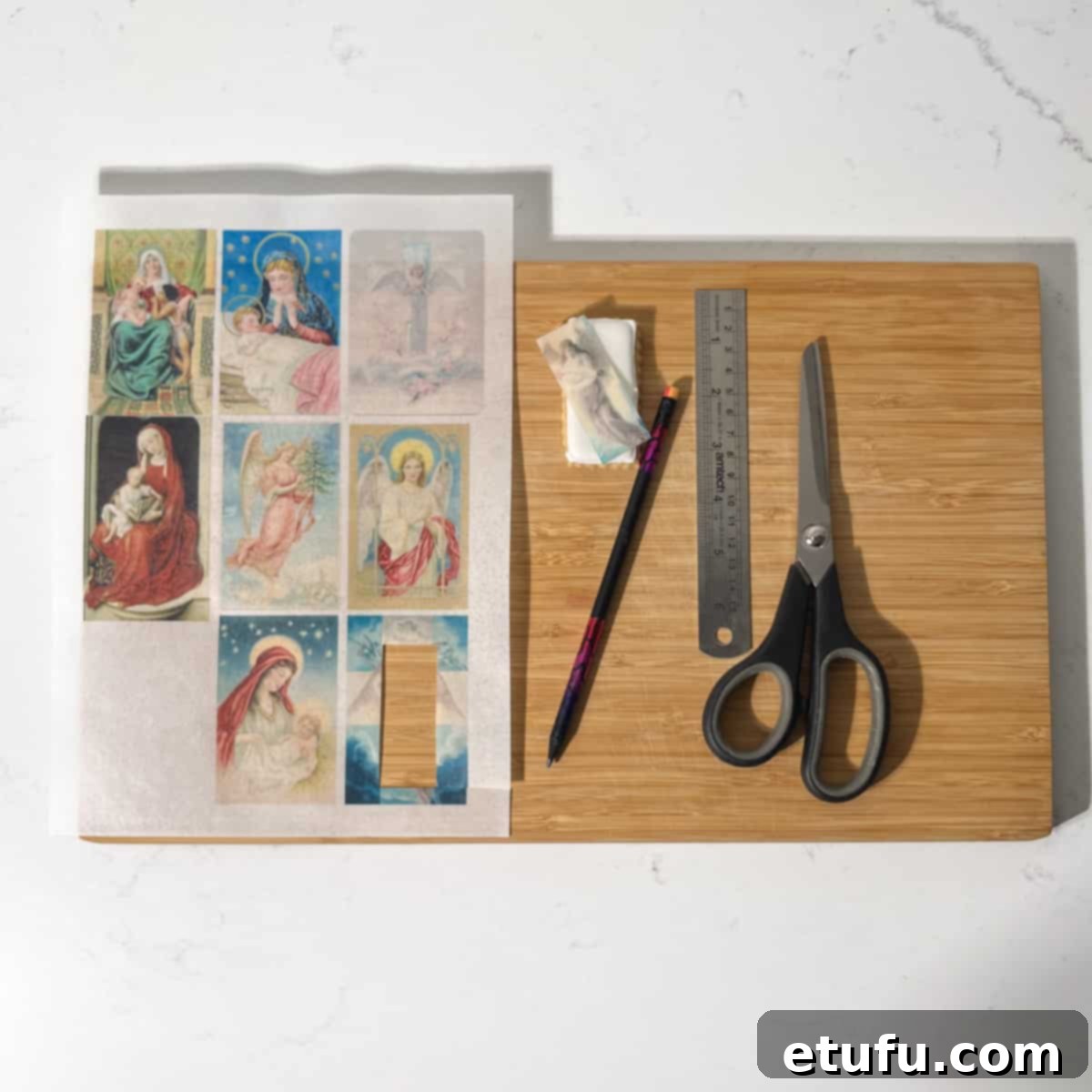 All the equipment needed for the Christmas cookies with edible wafer paper on a large chopping board: cookies, wafer paper, brush, water.