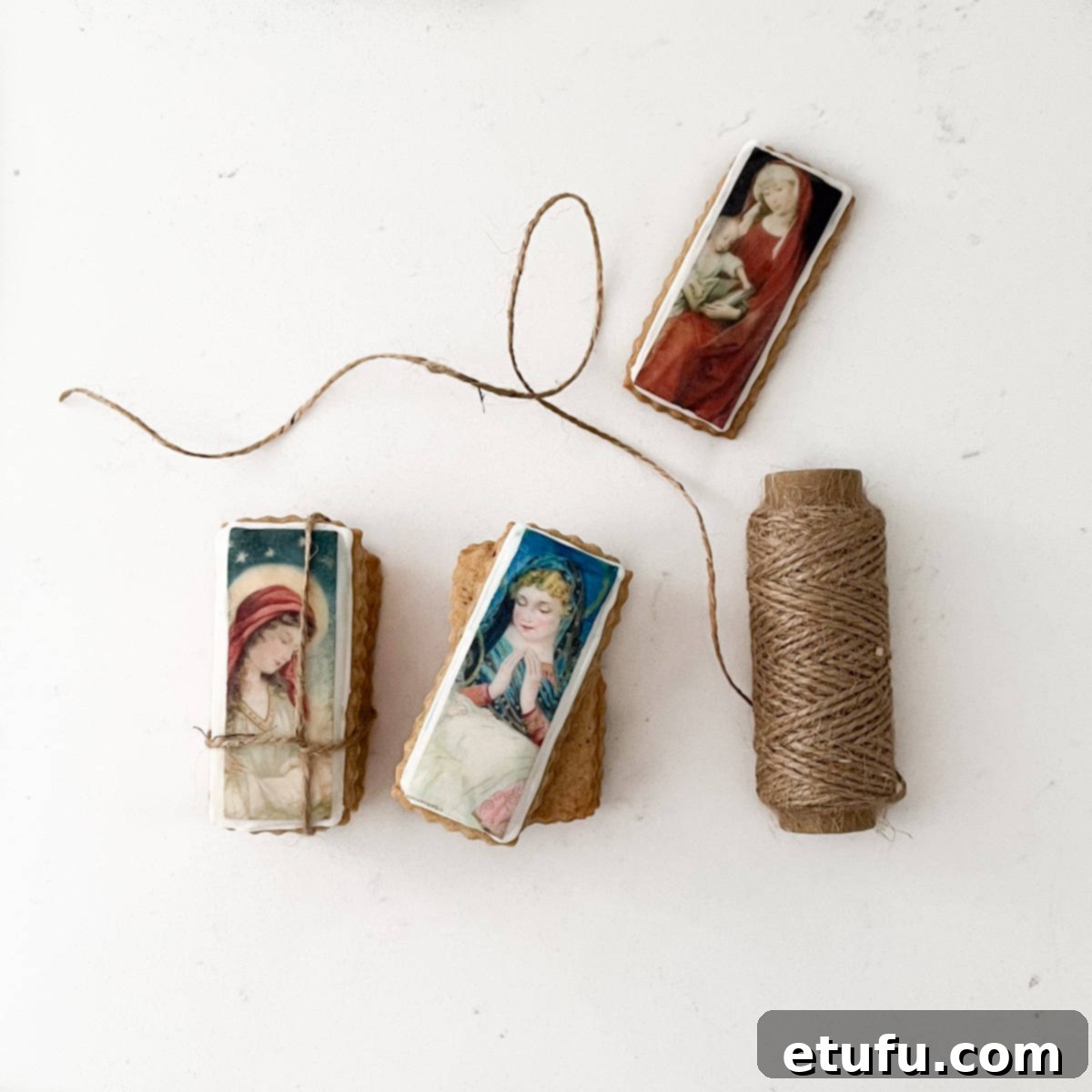 A pile of Christmas cookies with edible wafer paper tied together with a piece of string, perfect for gifting.