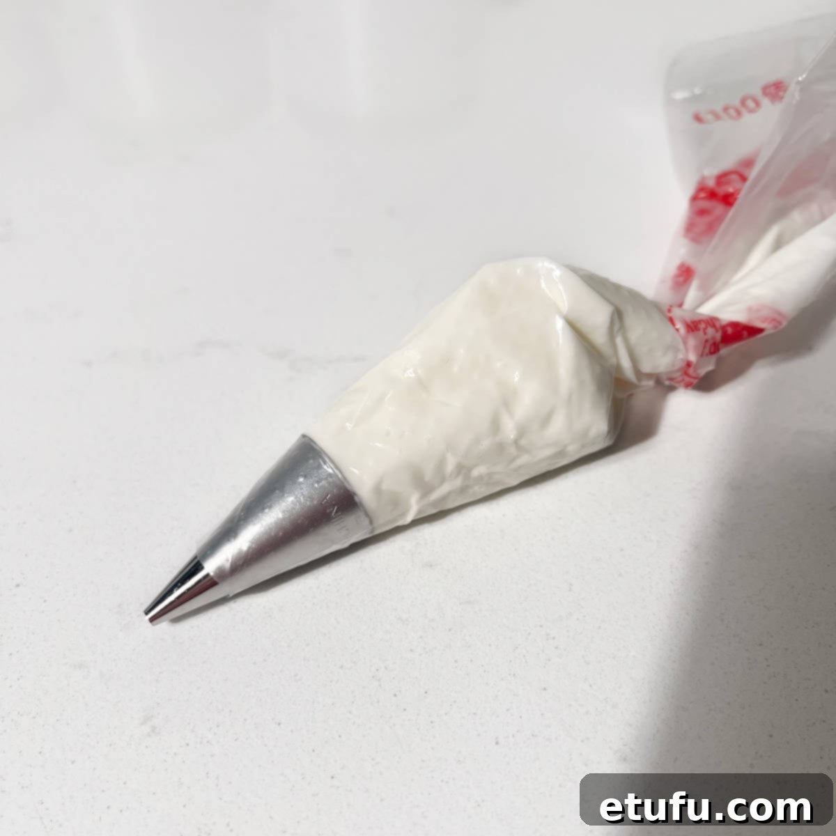 Royal icing loaded into a piping bag with a small round tip.
