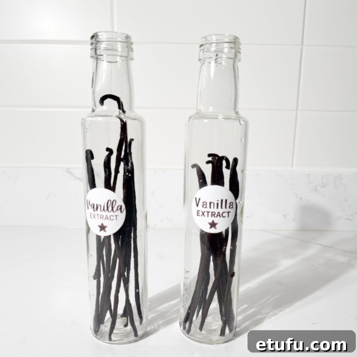 Two glass bottle with vanilla pods.