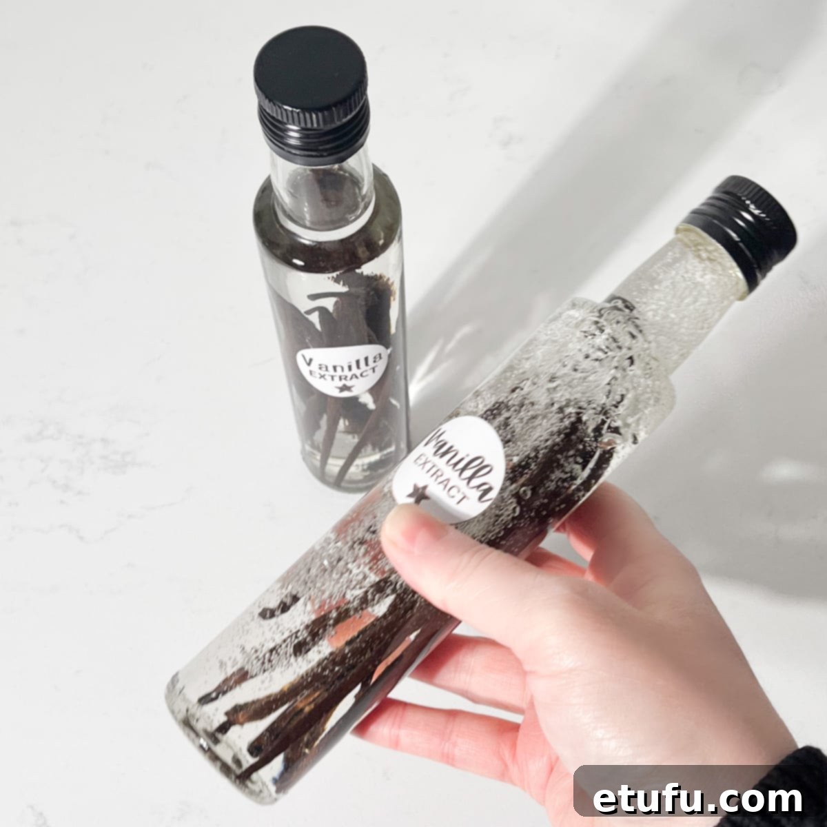 Shaking a bottle of homemade vanilla extract.