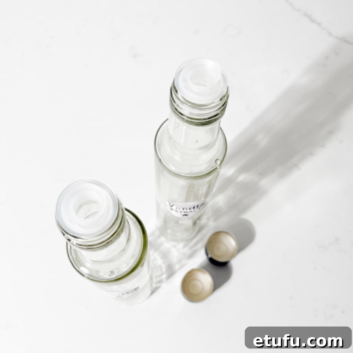 Two empty glass bottle on a white background.