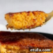 Sticky South African Malva Delight 18 A spoonful of malva pudding.