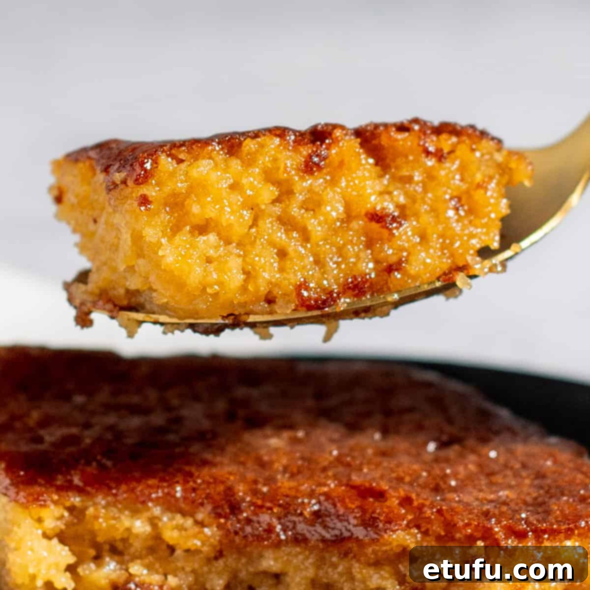 Sticky South African Malva Delight 4 A spoonful of malva pudding.