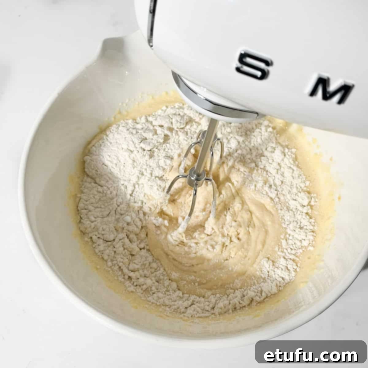 Sticky South African Malva Delight 10 Whisking the dry ingredients into the pudding batter.