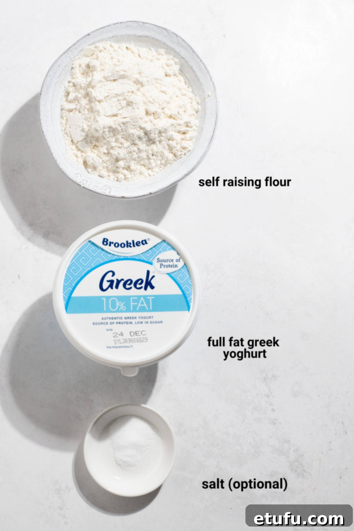 The essential ingredients for 2-ingredient flatbread: self-raising flour, Greek yogurt, and a small bowl of salt.