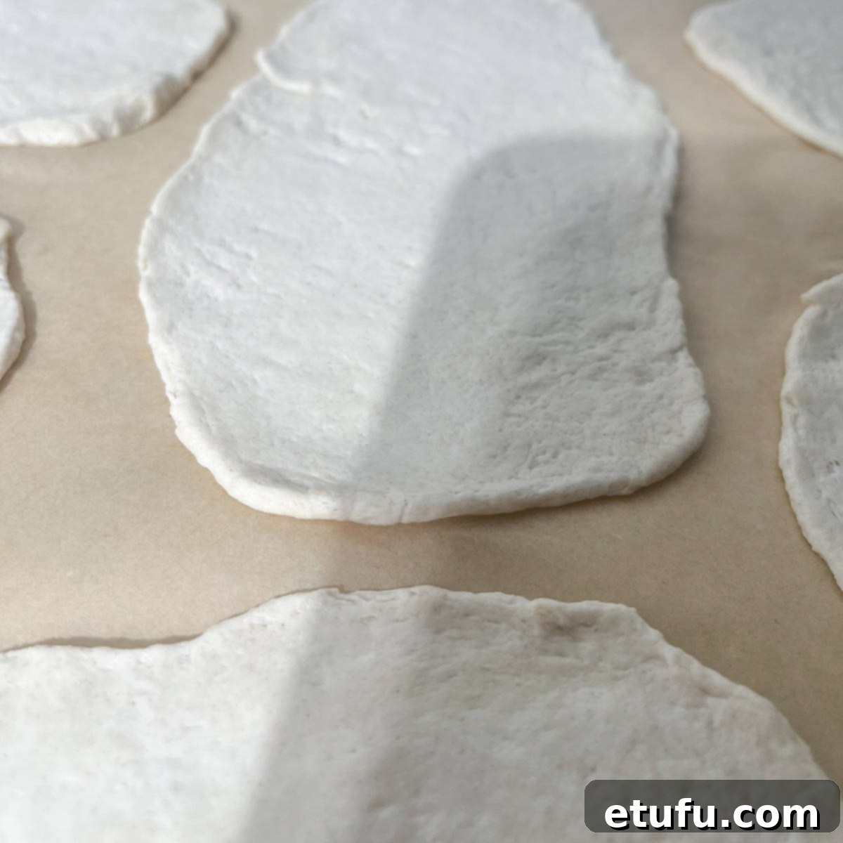 A rolled-out flatbread, showing its thickness of approximately 5mm (0.2 inches).