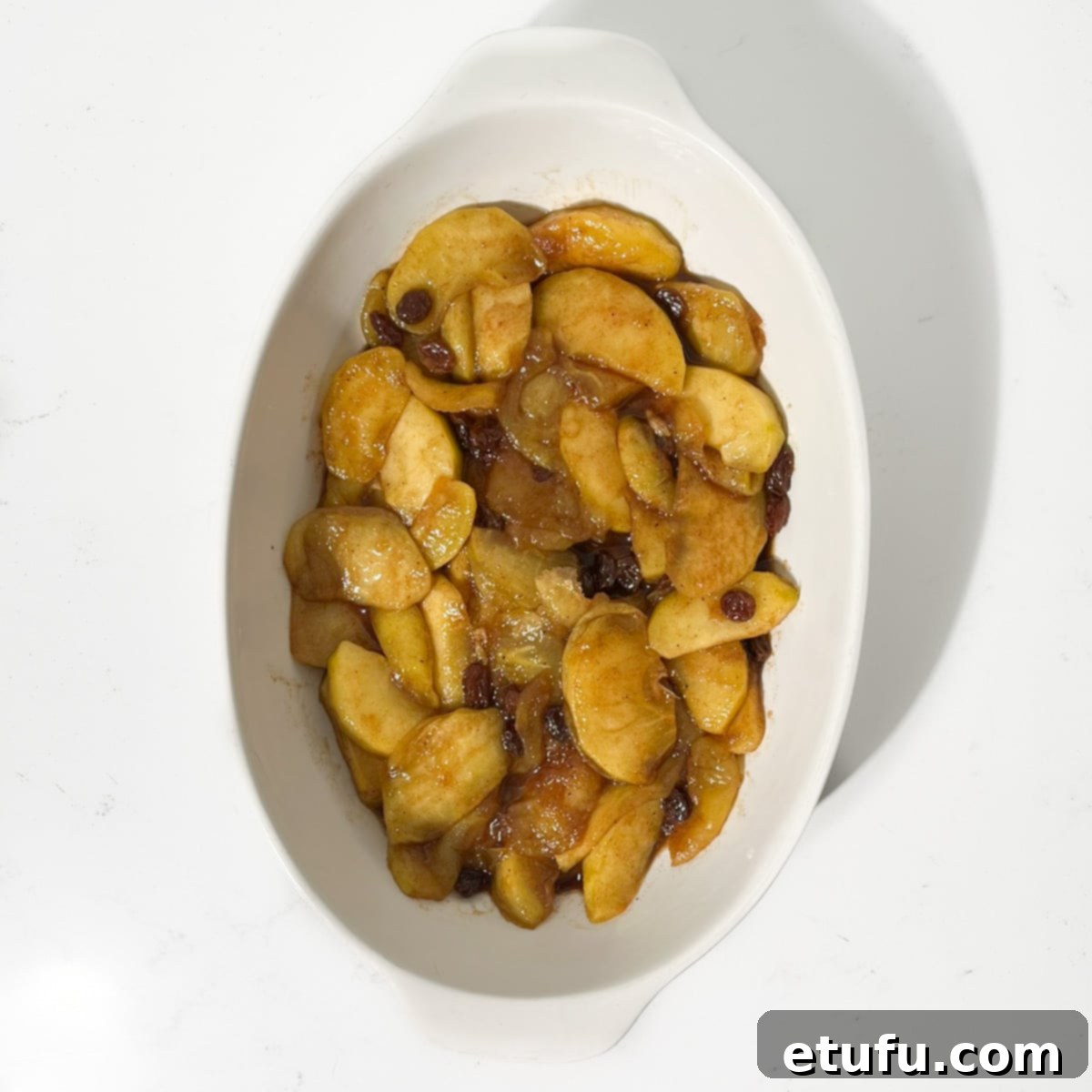 Cooked apples in a baking dish.