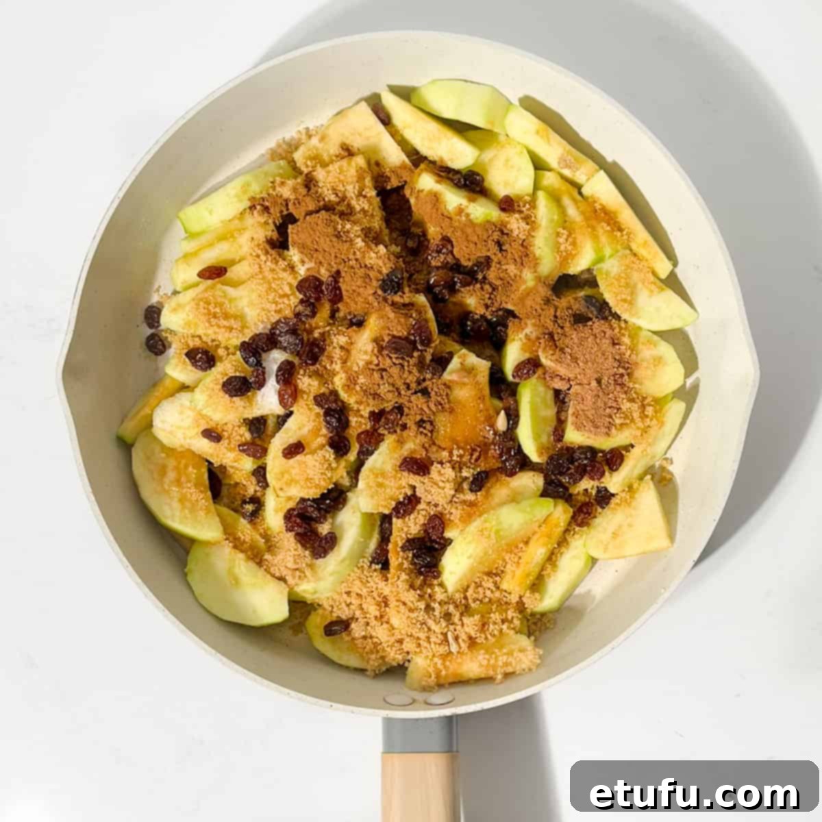 Adding all the ingredients for the apples to a large frying pan.