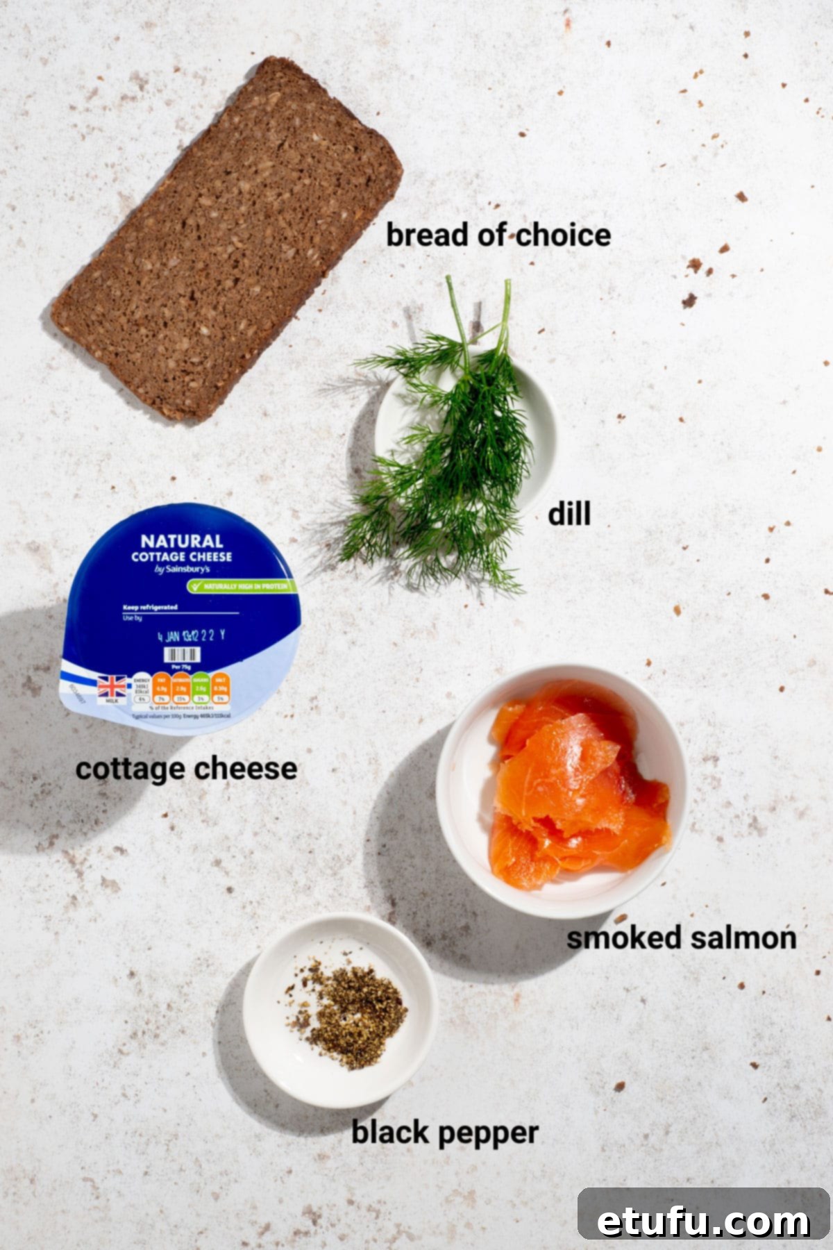 Ingredients for smoked salmon and dill cottage cheese toast, featuring salmon, dill, and bread.