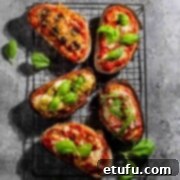 Five types of pizza toast on a cooling rack.