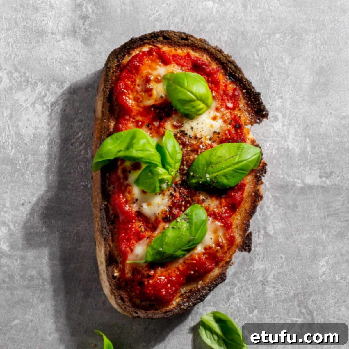 Margherita pizza toast on a grey background.
