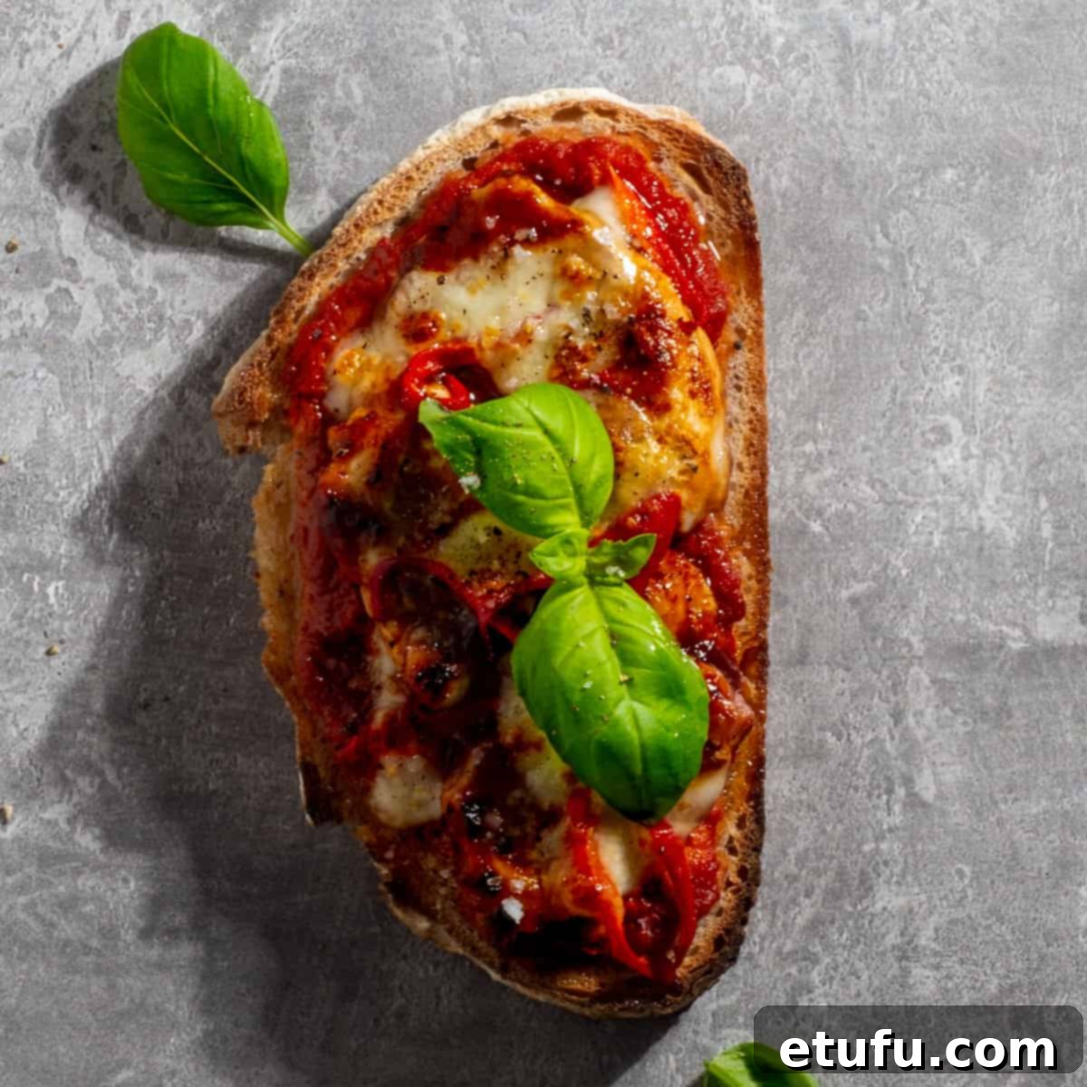 BBQ chicken pizza toast on a grey background.