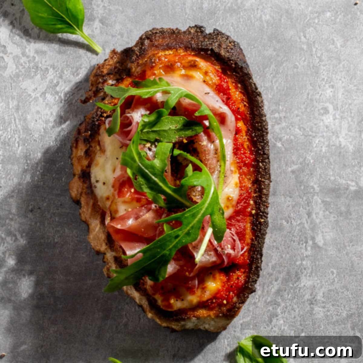Parma ham pizza toast on a grey background.