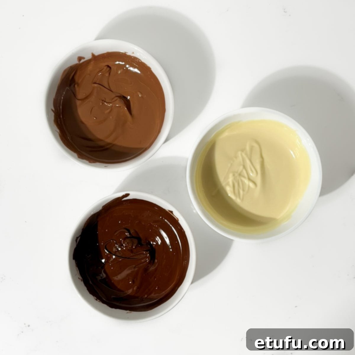 Three bowls of melted chocolate.