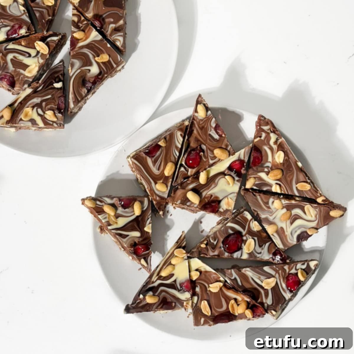 Chocolate tiffin triangles on a white plate.