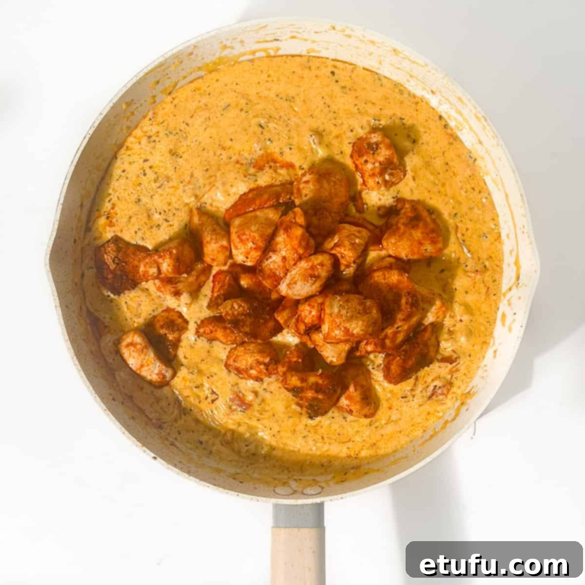 Exquisite Tuscan Marry Me Chicken Pasta 15 Adding the cooked chicken back into the pan with the sauce.