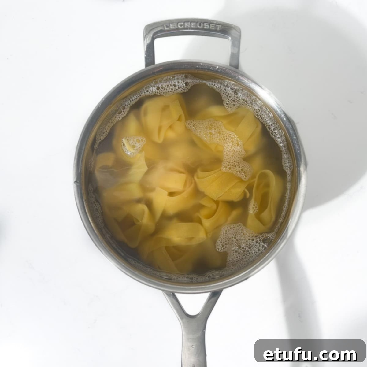 Exquisite Tuscan Marry Me Chicken Pasta 5 Cooking the pasta in a large saucepan.