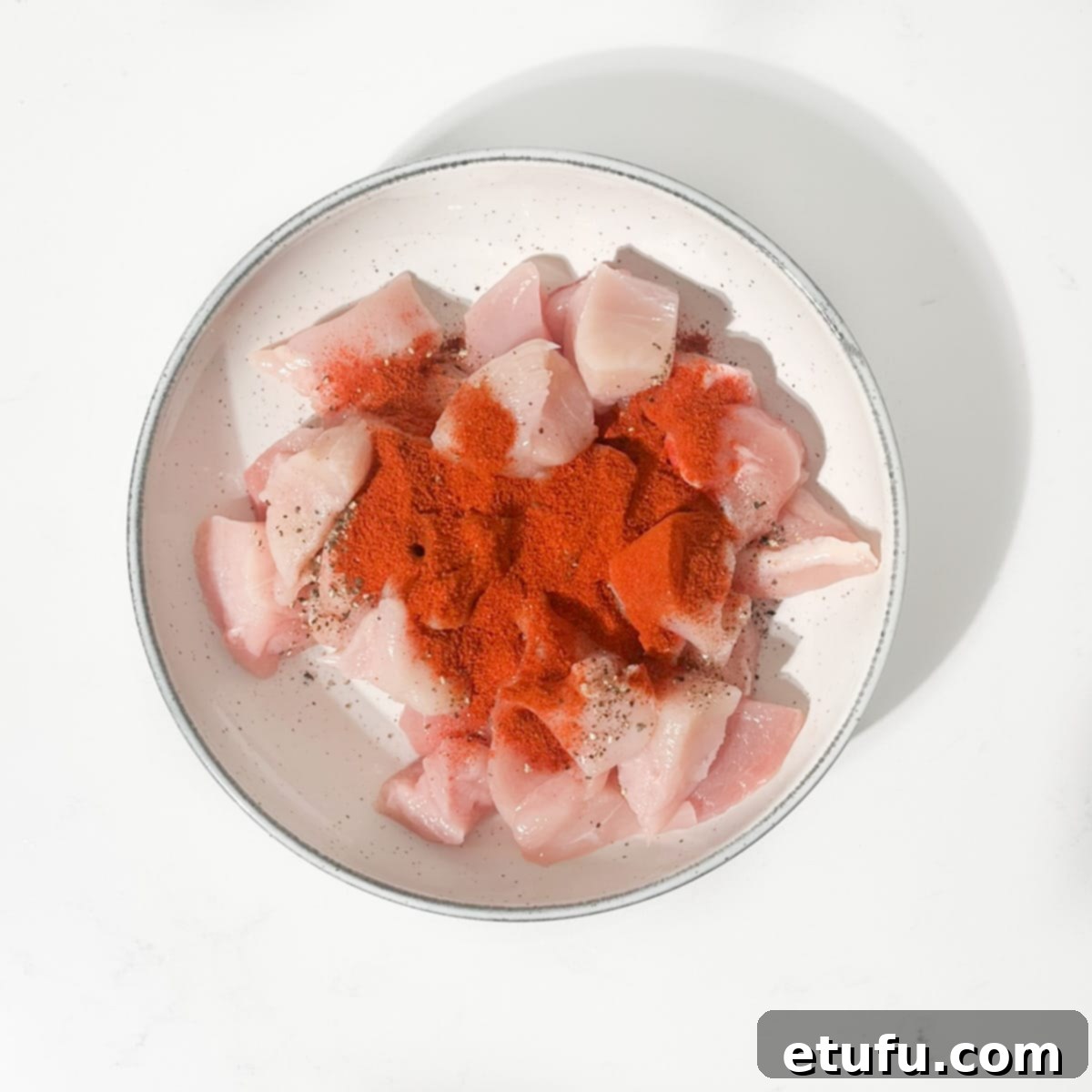 Exquisite Tuscan Marry Me Chicken Pasta 6 Coating the raw chicken with salt, pepper and smoked paprika in a white bowl.