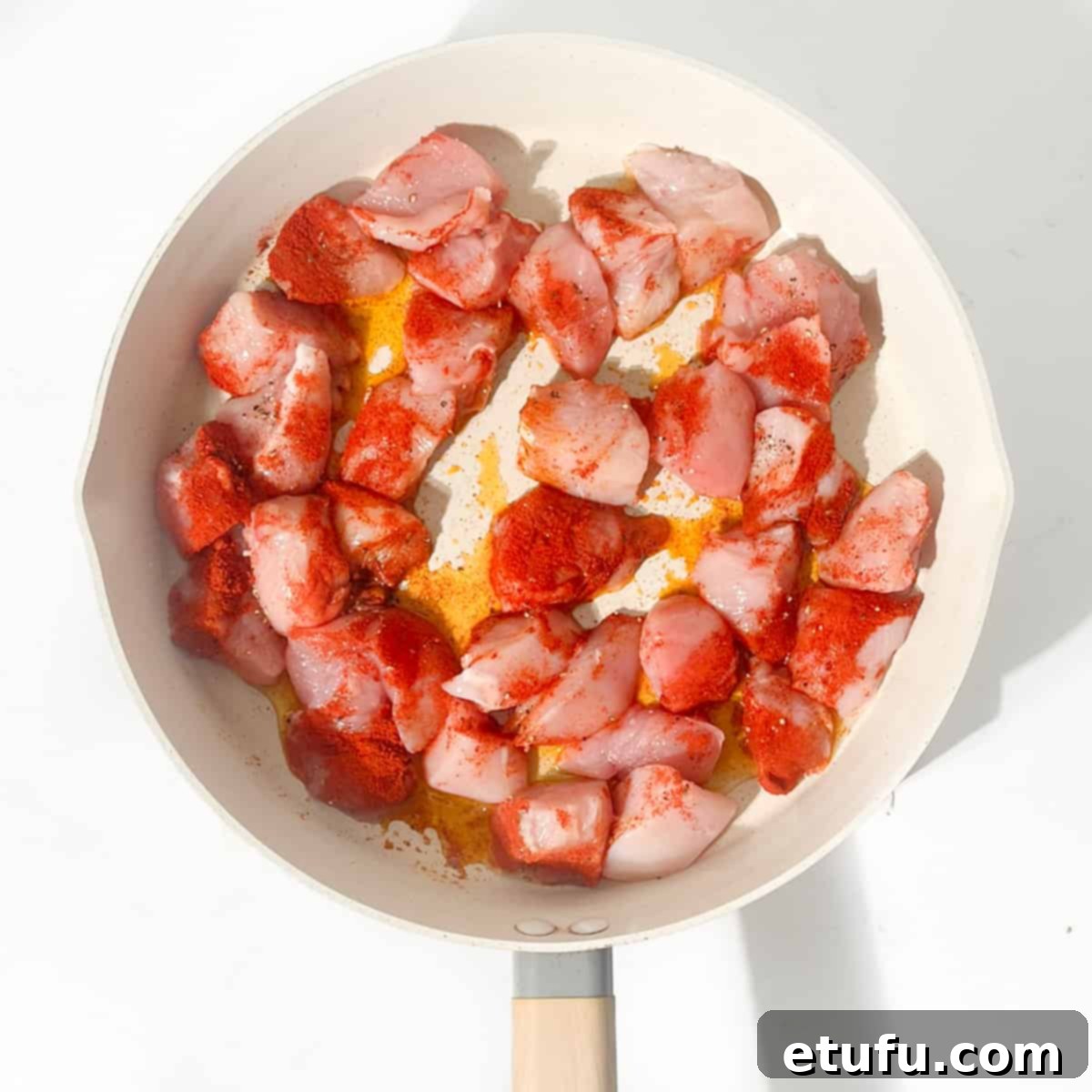 Exquisite Tuscan Marry Me Chicken Pasta 7 Adding the raw chicken to a large frying pan.