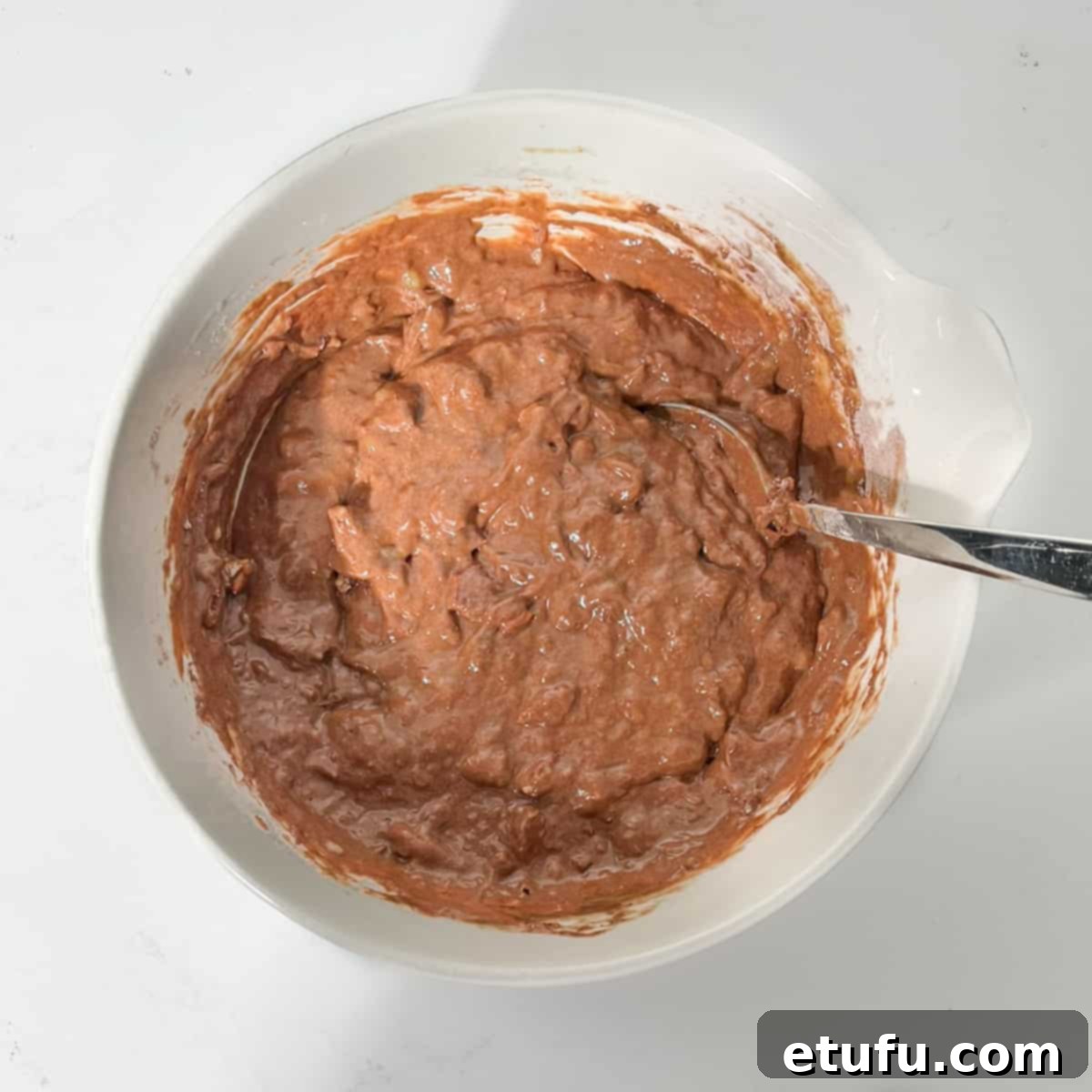 Golden Banana Chocolate Chunk Muffins 18 Baked banana chocolate chunk muffin mixture ready to be scooped into paper liners.
