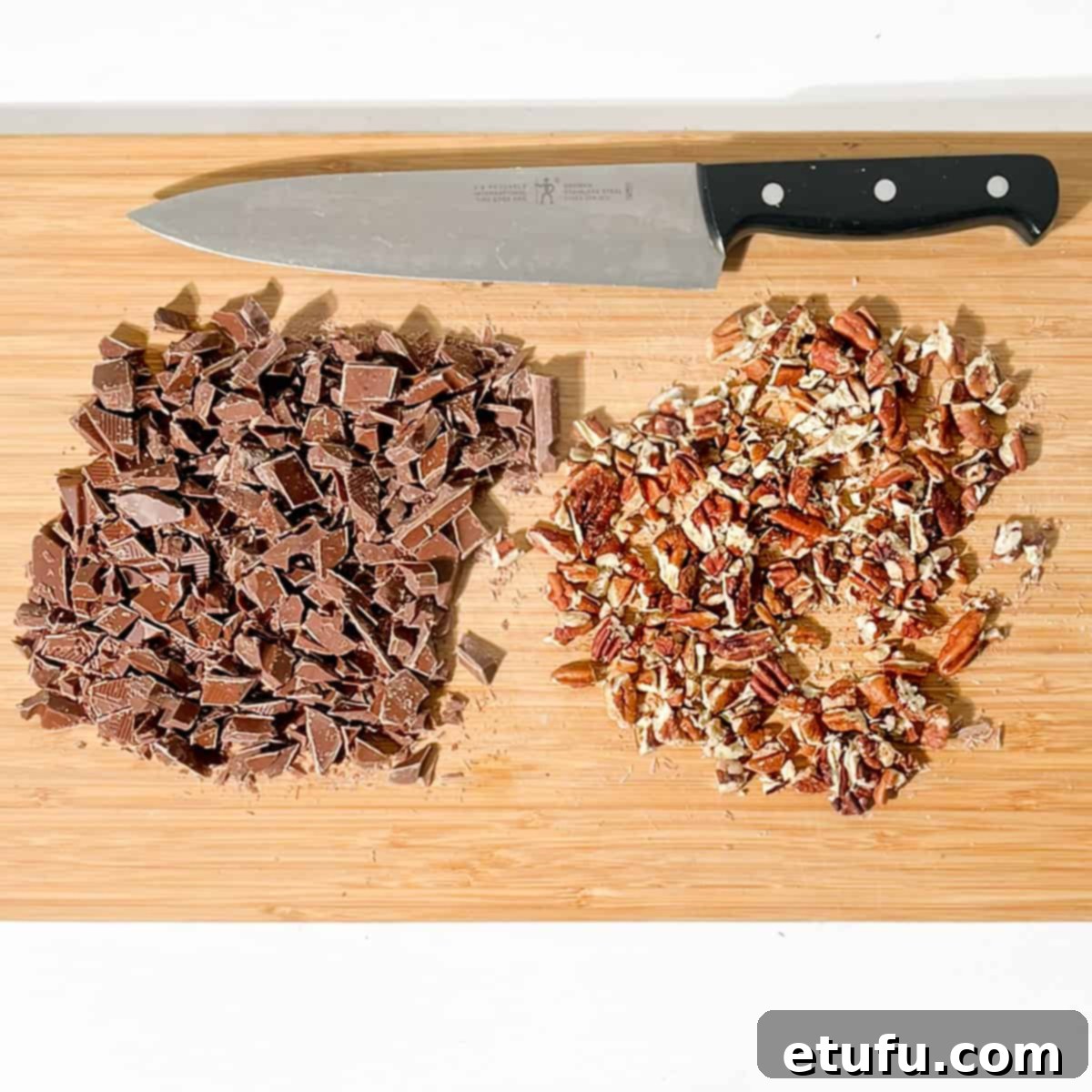 Golden Banana Chocolate Chunk Muffins 6 Chopped chocolate and pecan nuts on a chopping board.