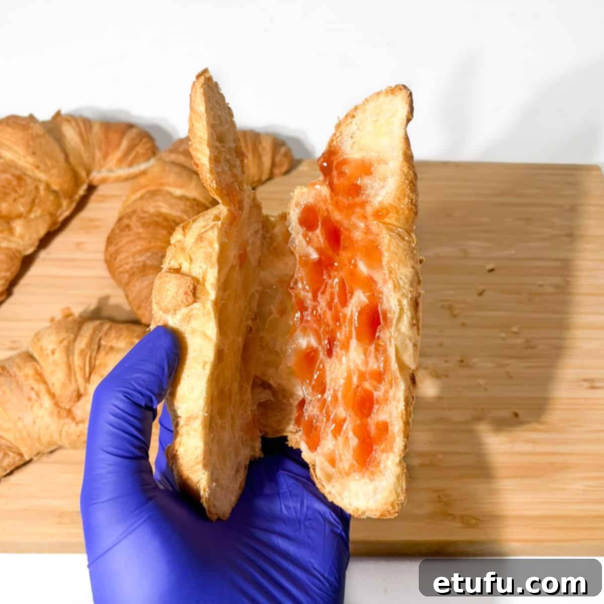 Spreading jam on the croissants.