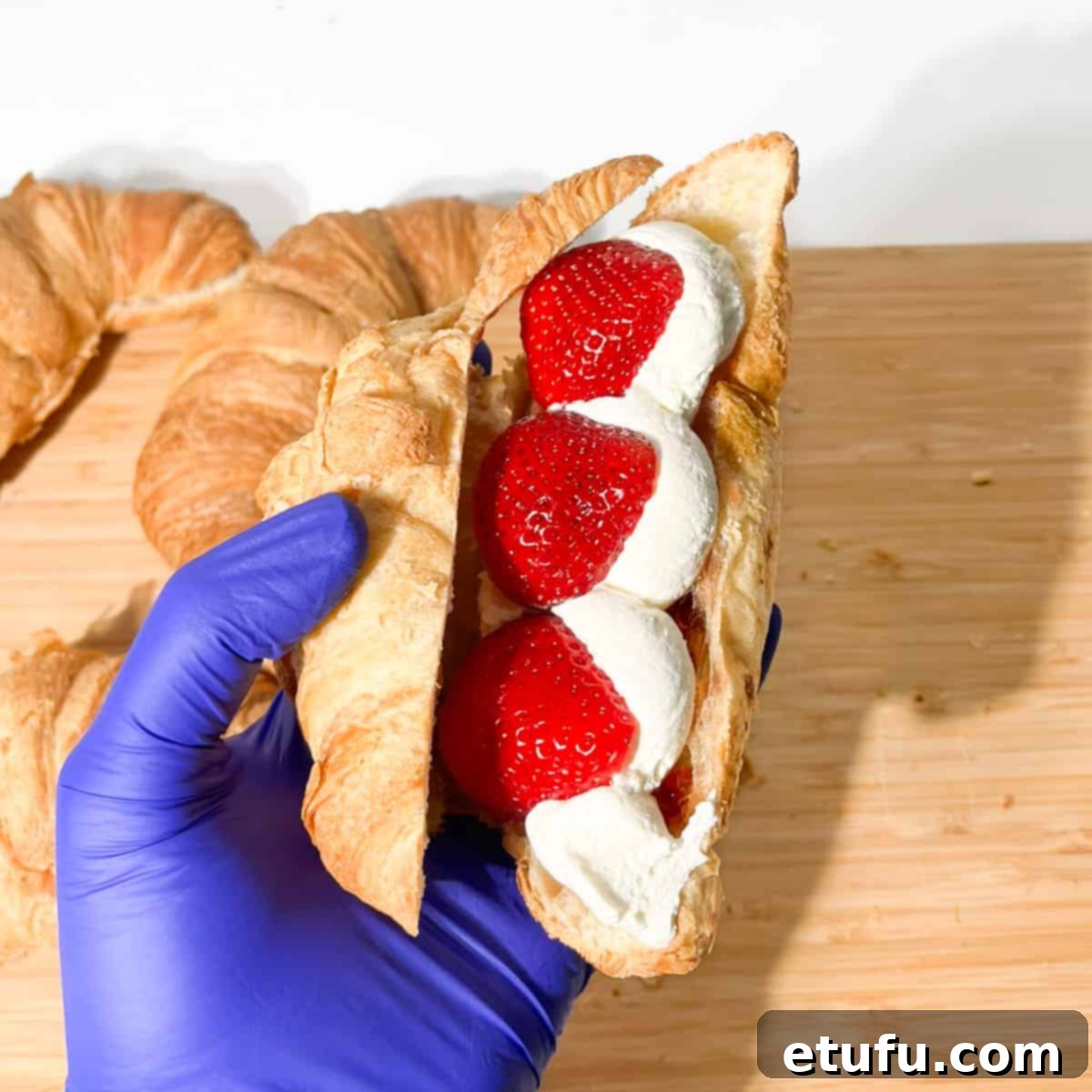 Layering the strawberries into the strawberry croissant.