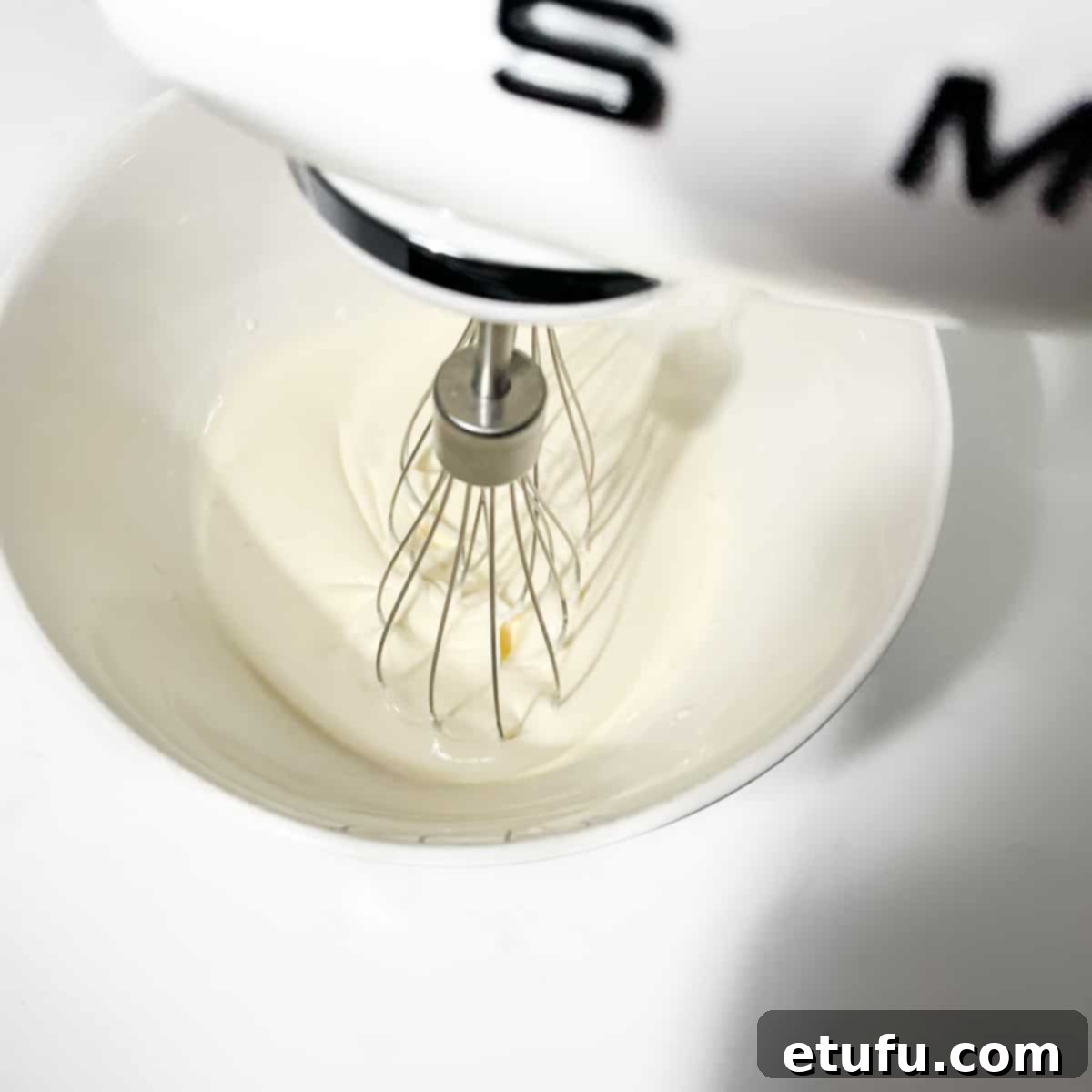 Whipping the double cream for the strawberry croissants.