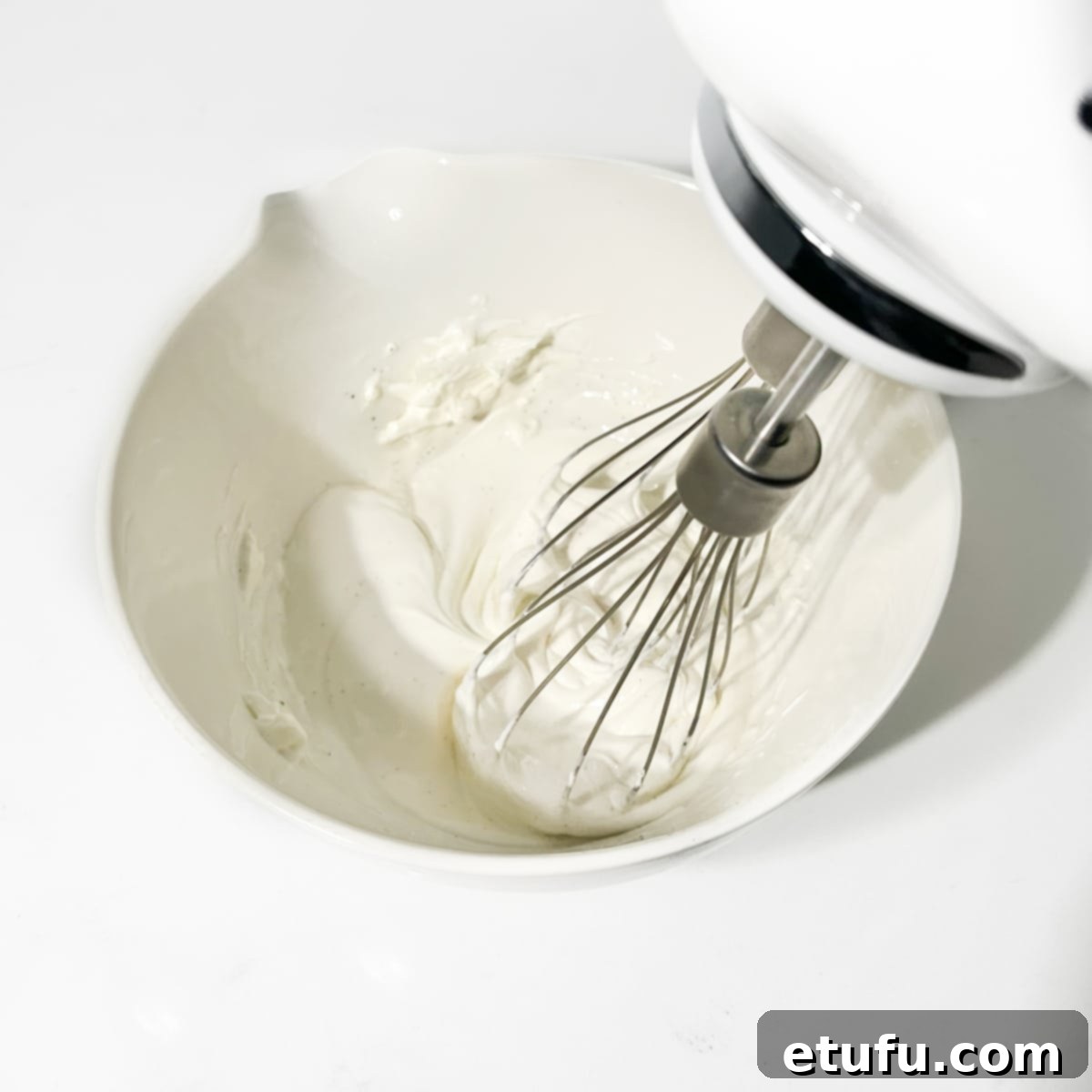 Whipping the mascarpone in a small bowl until smooth.