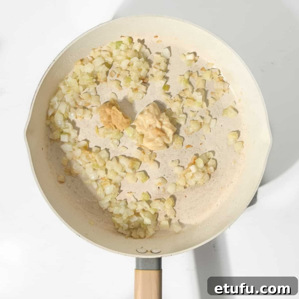 Adding garlic and ginger to onions.