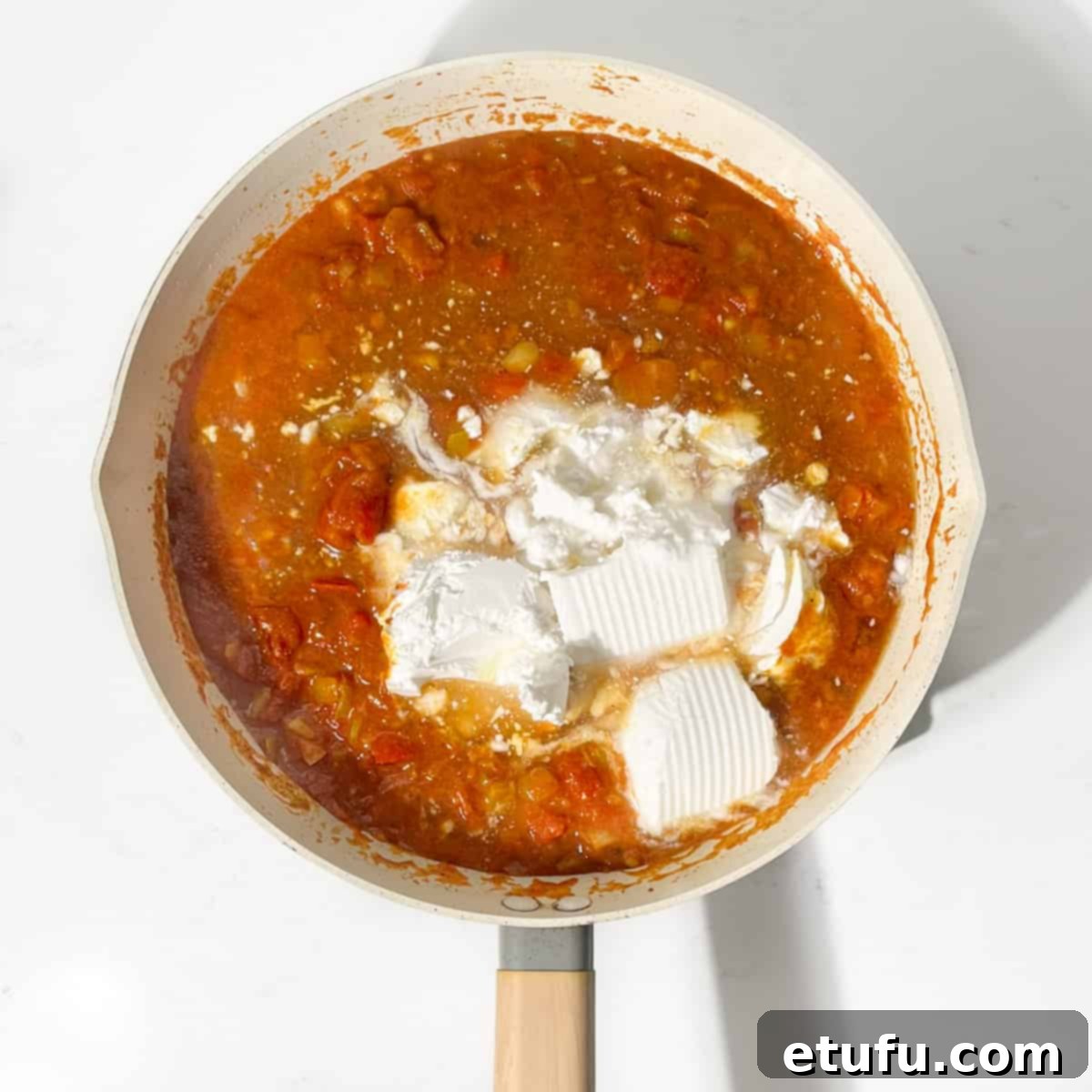 Adding coconut milk to the butter bean curry.