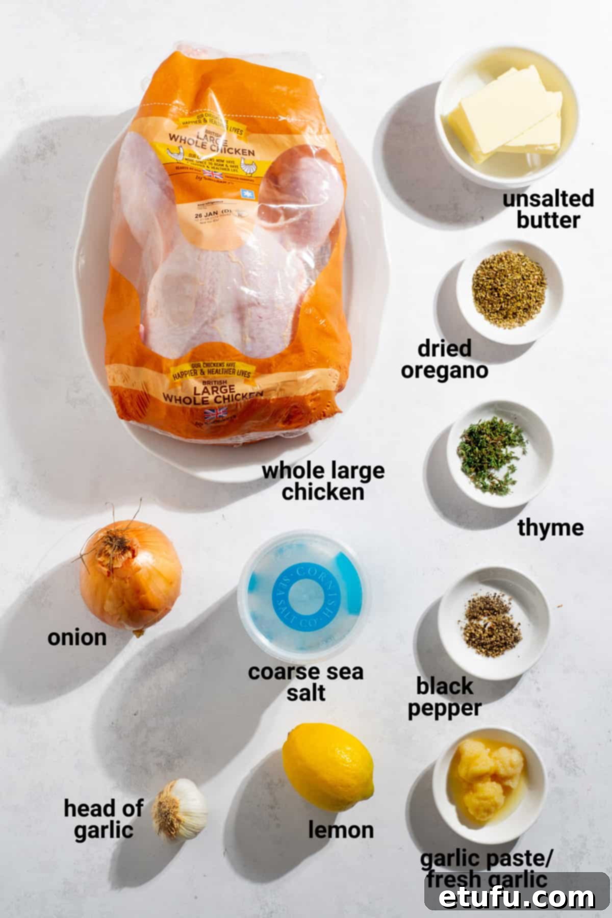 Greek roast chicken ingredients laid out on a kitchen counter.