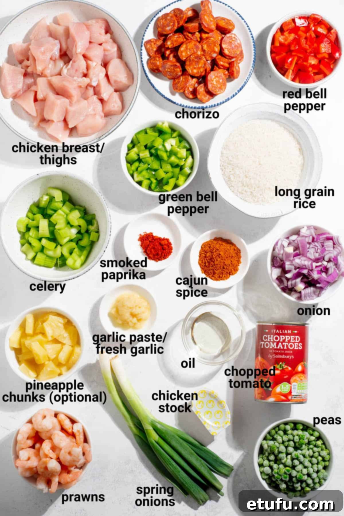 A vibrant selection of fresh ingredients laid out for chicken and chorizo jambalaya preparation.