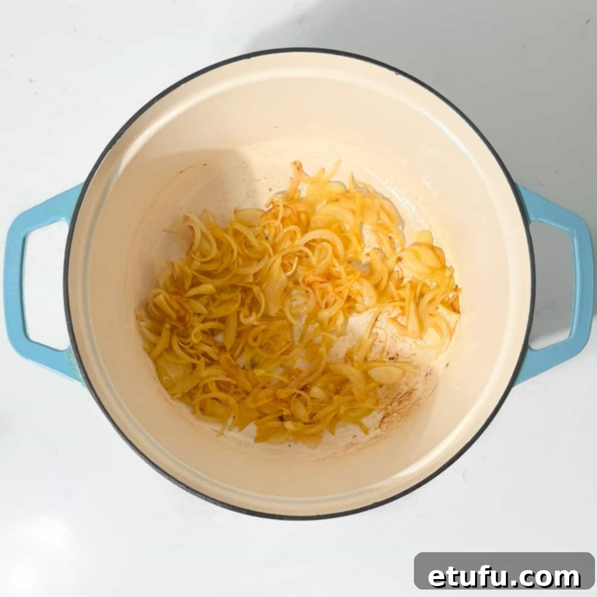 Caramelising the onions in a large saucepan.