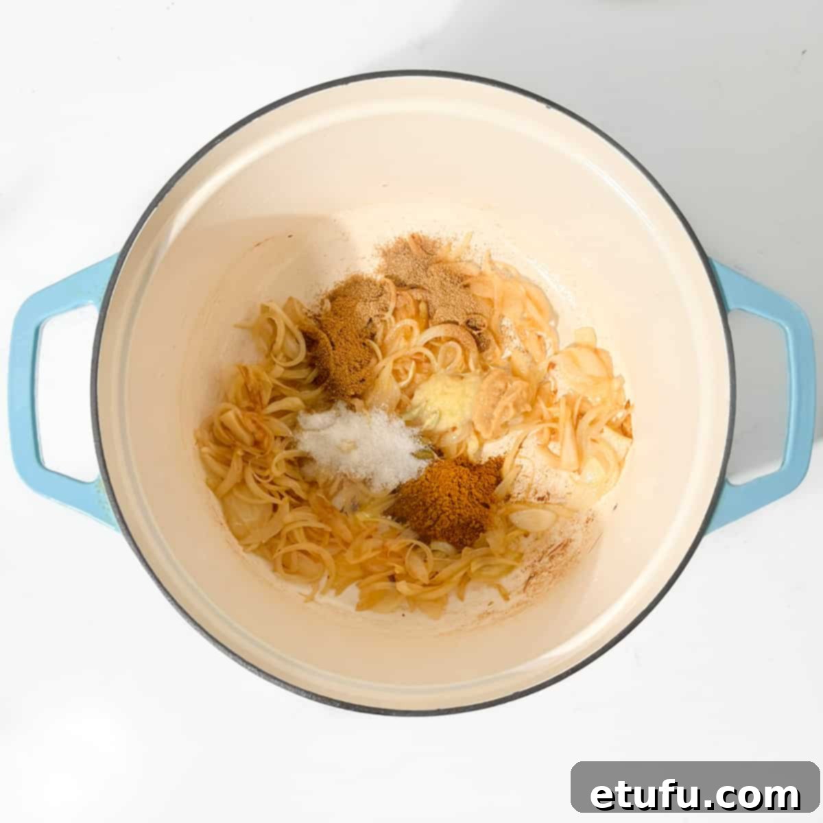 Adding all the spices to the caramelised onions.