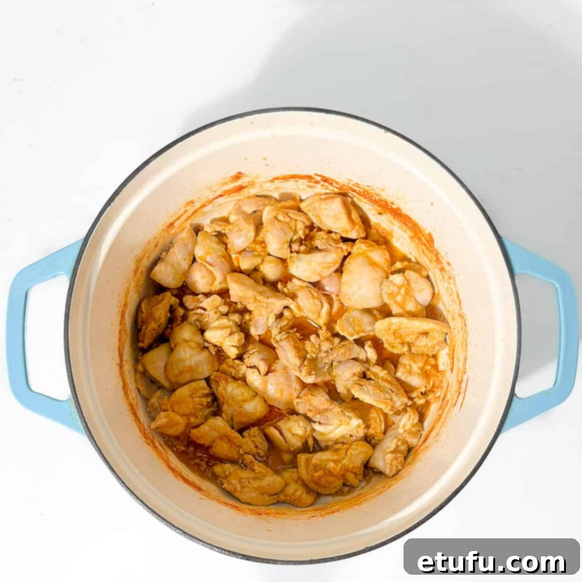 Browning the chicken in a large saucepan.